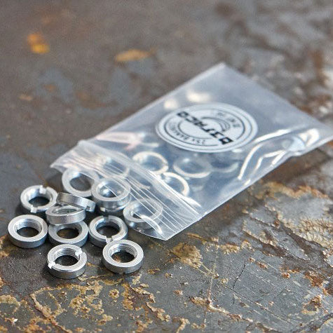 A pack of Befaco White Bananuts, anodised aluminium custom 3.5mm socket nuts, displayed on a metallic surface.