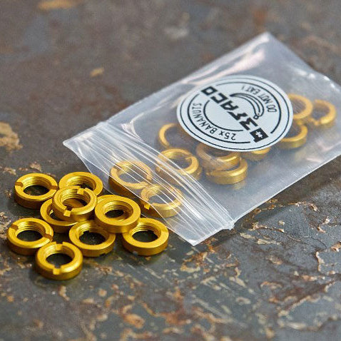 A clear plastic bag containing multiple yellow anodised aluminium socket nuts, with the Befaco logo visible on the bag.