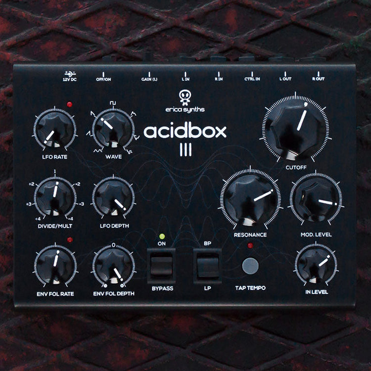 Erica Synths Acidbox III audio effect pedal with various control knobs and switches on the front panel, housed in a black aluminum enclosure.