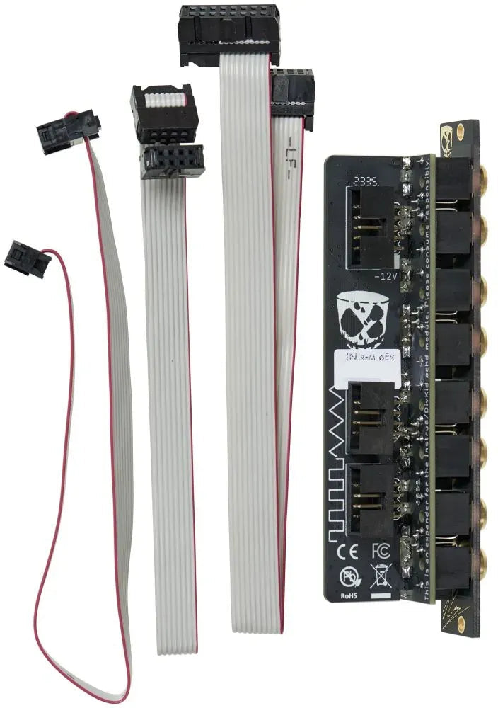 Modular Synth components including module, and ribbon cables on a white background