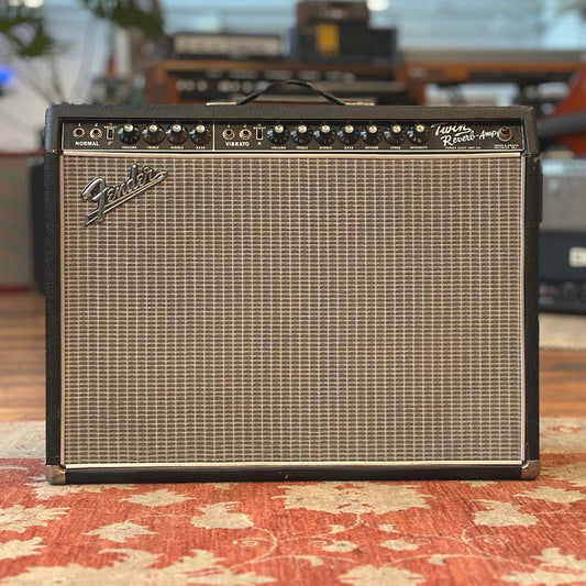 Fender guitar amplifier on a patterned rug with blurred background
